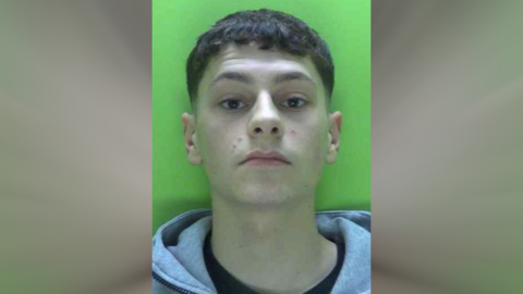 A police custody image of Harrison Cudworth against a green background