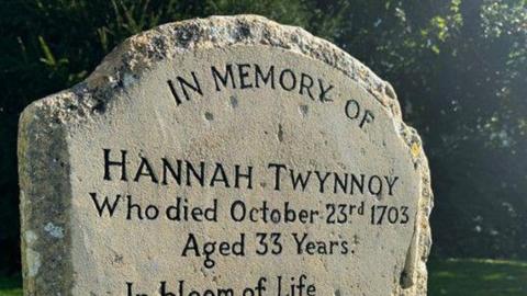 A close-up of the headstone detailing Hannah Twynnoy's date of death and showing a poem which includes the words, "For Tyger fierce Took Life away".