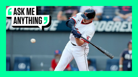 Kyle Manzardo of the Cleveland Guardians swinging at the ball with an Ask Me Anything border around him