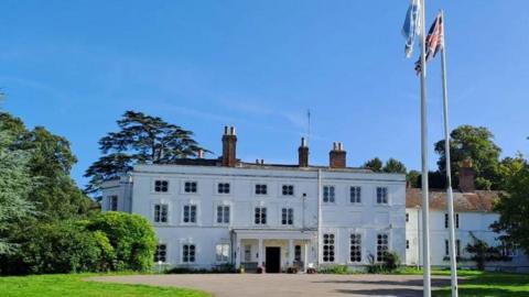 Exterior of Foxlease - whitewashed Georgian house with three storeys