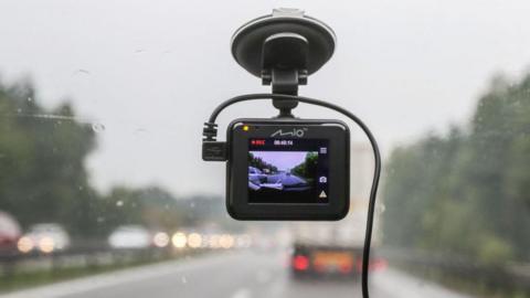 A dashcam in a car on a motorway.