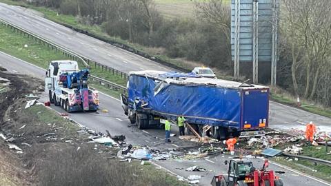 a lorry crashed over the central reservation of the a1 - with rubbish strewn everywhere