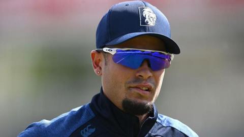 Codi Yusuf looks on with his hat and sunglasses on