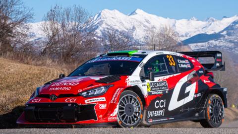 Elfyn Evans' Toyota Yaris with a snowy mountain backdrop