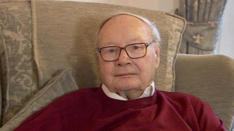 David Baker, pictured in 2021, sat at home, looking at the camera