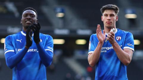 Chesterfield's Freddie Ladapo (left) and Sam Curtis applaud their travelling fans after the 2-2 draw at MK Dons
