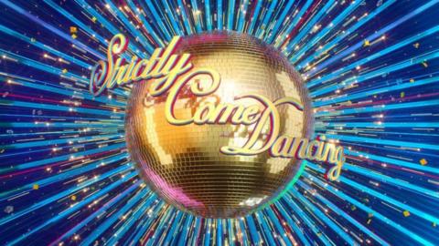 A gold glitterball with Strictly Come Dancing written in front of it.