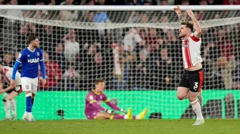 Ryan Manning celebrates as Ipswich players look forlorn