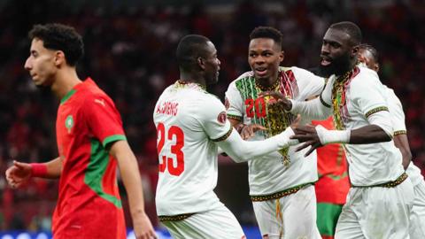 Lassine Sinayoko (far right) celebrates a goal for Mali