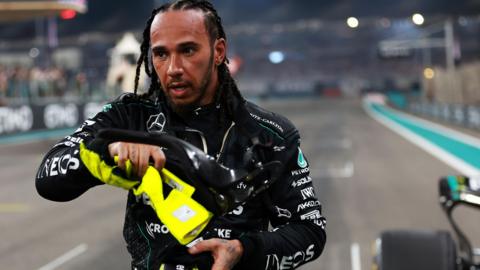 Lewis Hamilton takes off his balaclava after finishing the Abu Dhabi Grand Prix