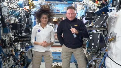 Suni Williams and Butch Wilmore float in an International Space Station module