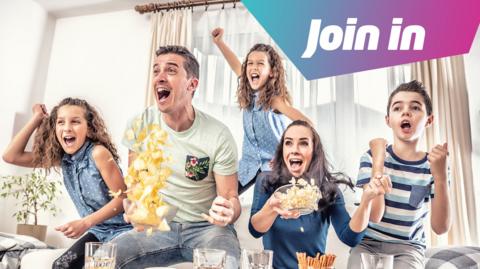 A family with food celebrating watching a game on tv.