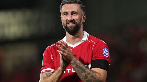 A smiling Ollie Palmer applauds Wrexham's fans
