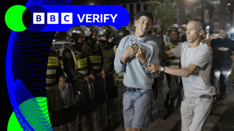 A protester is led away from a demonstration in Rabat, Morocco, on Wednesday