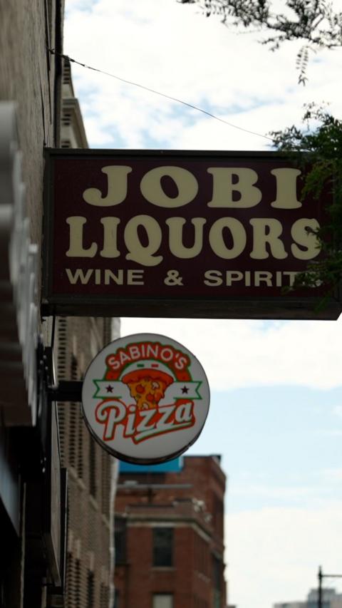 Street sign with Jobi Liquors written on it