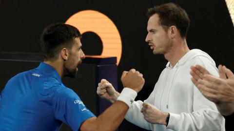 Novak Djokovic celebrates with Andy Murray