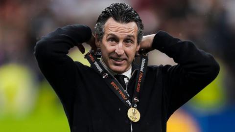 Unai Emery, head coach of Aston Villa FC, adjusts his medal during the award ceremony following the Uefa Europa League 2025-26 final football match between SC Freiburg and Aston Villa.