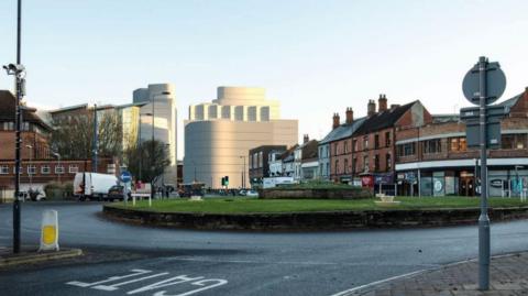 Designs for a new development in Derby city centre are generated in this image behind a roundabout
