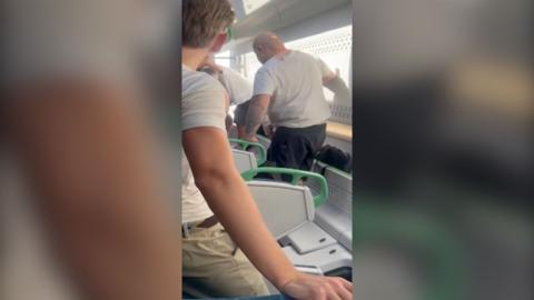 Screengrab showing inside derailed train carriage