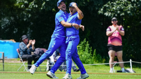 Harry Manenti celebrates taking a wicket against Scotland