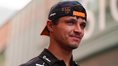 McLaren's Lando Norris wearing a McLaren cap back to front