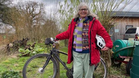 Rhiannon Ridgewell standing beside her bike