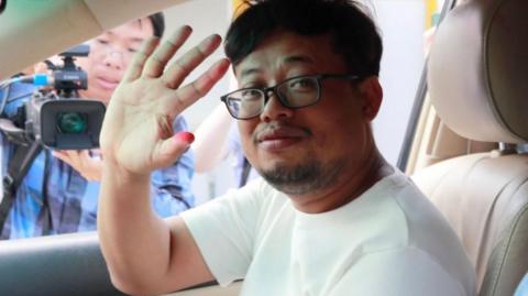 Mech Dara waves after being released from Kandal jail, Cambodia, on 24 October.