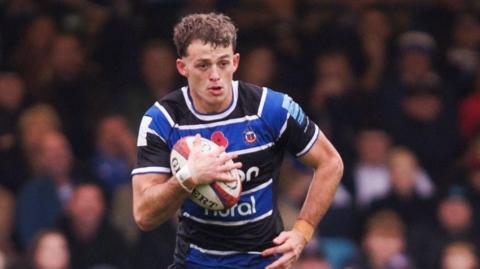 Louie Hennessey running with the ball during Bath's Premiership Rugby Cup win against Bristol