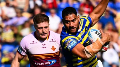 Kelepi Tanginoa of Warrington tries to evade a tackle against Huddersfield