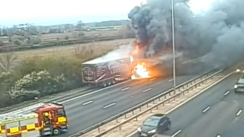 A lorry on fire on the motorway