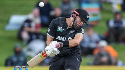 New Zealand batter Daryl Mitchell weaves out of the way of the ball