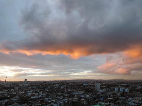 Setting sun reflecting against a large rain cloud 