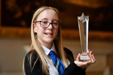 Jasmin Notarangelo, winner of the 2024 Young Scientist of the Year award, holds up her award