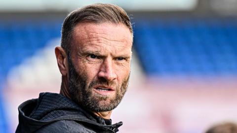 Blackpool boss Ian Evatt looks on