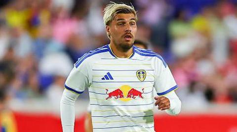 Joel Piroe in white Leeds shirt, with blue and yellow vertical pinstripes and blue stripe trim