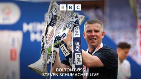 Bolton boss Steven Schumacher holding a trophy