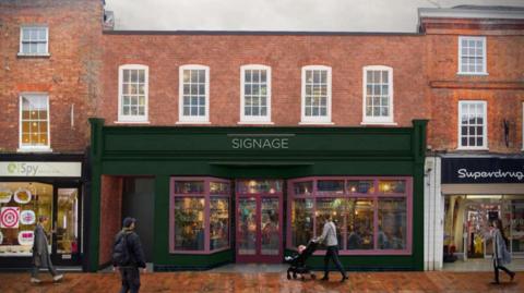 An artist's impression of the outside of the former clothes shop which shows the woodwork painted a dark green and pink trimmed windows. There is a superdrug store next door and people are walking on the pavement