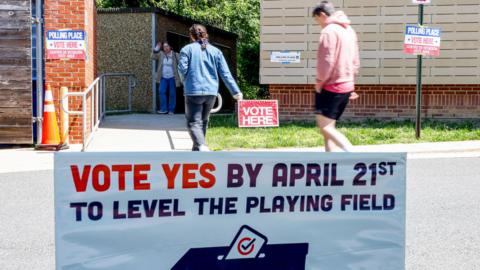 A "Vote Yes" sign as voters arrive to cast their ballots at a polling location inside Abingdon Elementary School during a special election in Arlington, Virginia, US, on Tuesday, April 21, 2026.