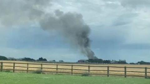 Smoke rising from a barn fire in Catwick, East Yorkshire