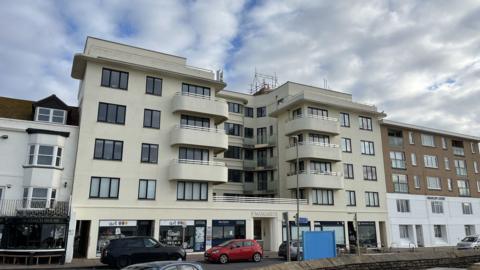 St Margaret’s Court, a cream building with windows and balconies