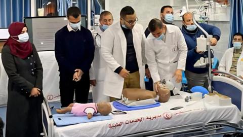 Medical students train with plastic dummies.  