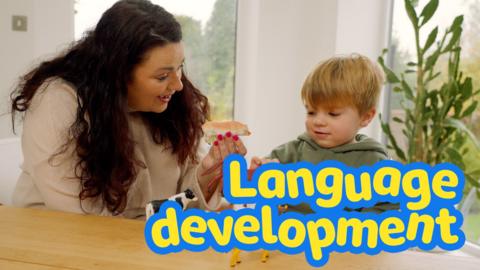 Mother and son playing with toy animals