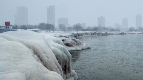 Frozen city lake with very icy conditions along the shore