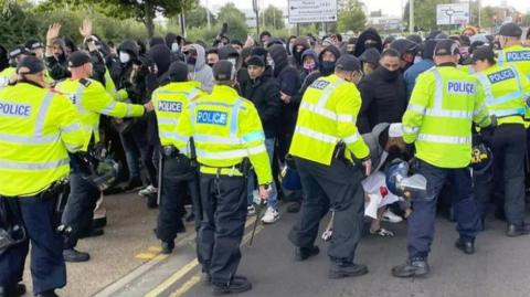 Police face protesters in Melton Road