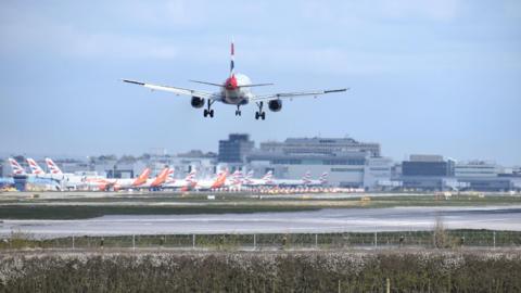 A plane lands on a runway. 