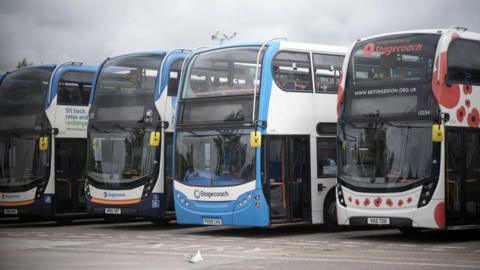 Four Stagecoach buses side-by-side in a car park.