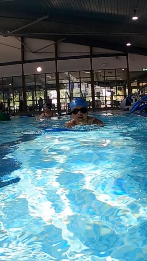 A woman in a swimming pool.