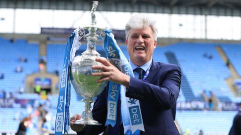 Coventry City owner Doug King celebrates with the championship trophy after the Championship match between Coventry City and Wrexham AF