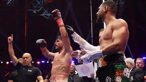 Josh Kelly has his arm raised