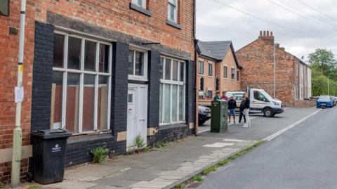 A general view of Crosby Street in Darlington. It is a residential street with terraced houses either side and cars parked on the street.